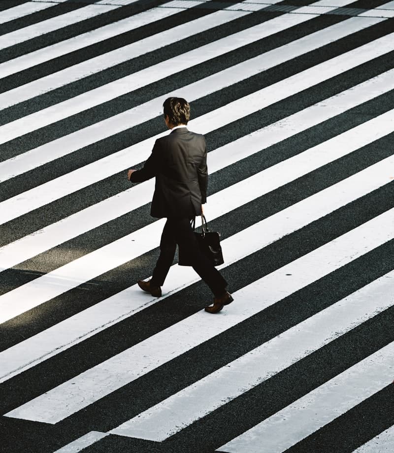 Person walking through a busy crossing on the move